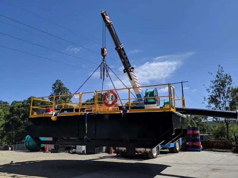Crane lifting a pontoon pump station with handrailed walkway deck for the BHP/BMA tailings storage project, Moranbah, QLD