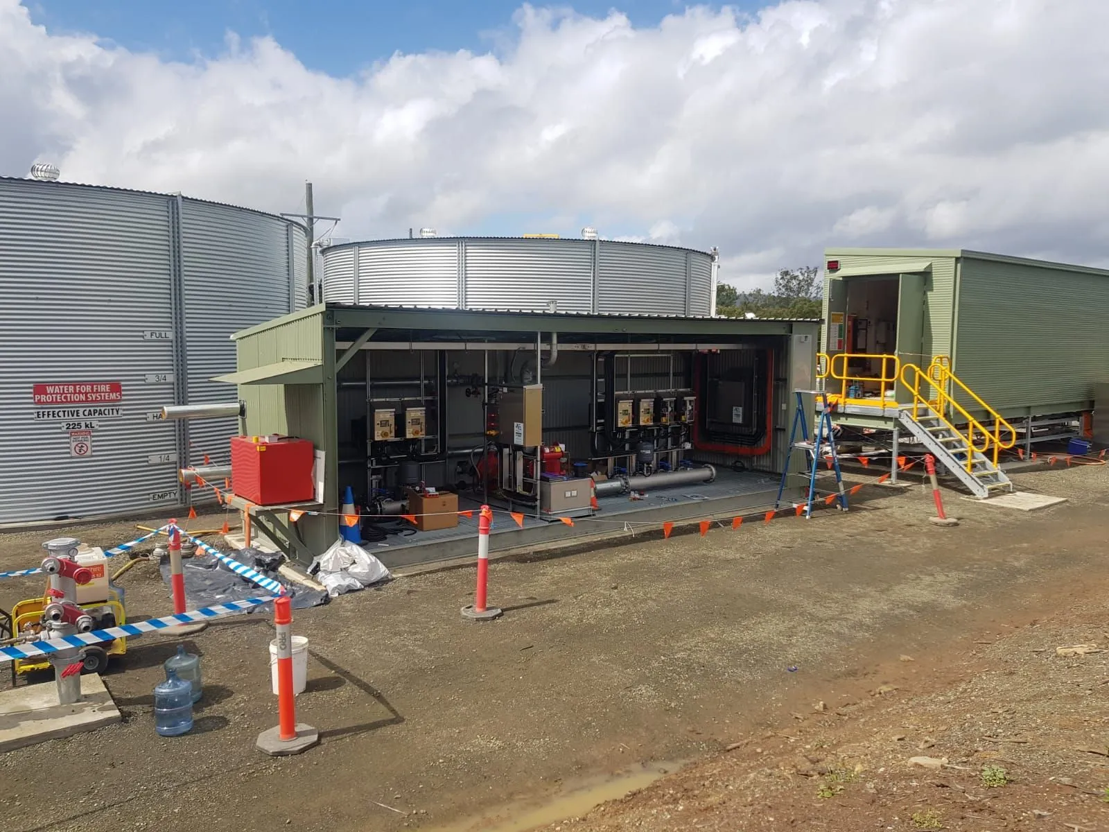 Modular fire pump station shelter beside a large fire water tank at Wambo United, Hunter Valley, NSW