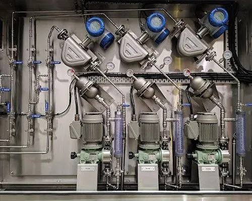 Dosing pumps and flow meters mounted in a stainless reagent cabinet for the Ravensworth CHPP, Hunter Valley, NSW