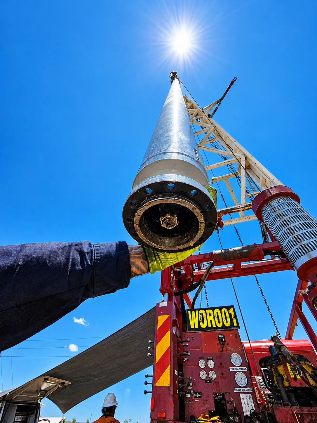 Borehole submersible pump being lifted on the drilling rig at Emerald, Queensland