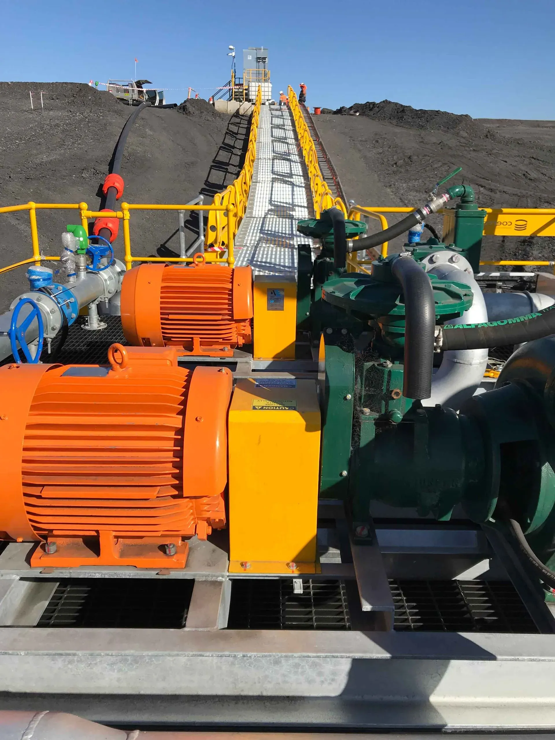 Floating walkway and pontoon pump station on a mine water storage