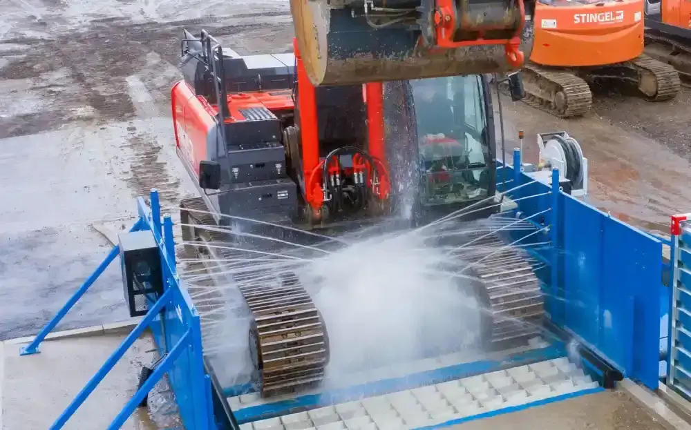 Haul truck passing through a drive-through wheel wash on a quarry exit road
