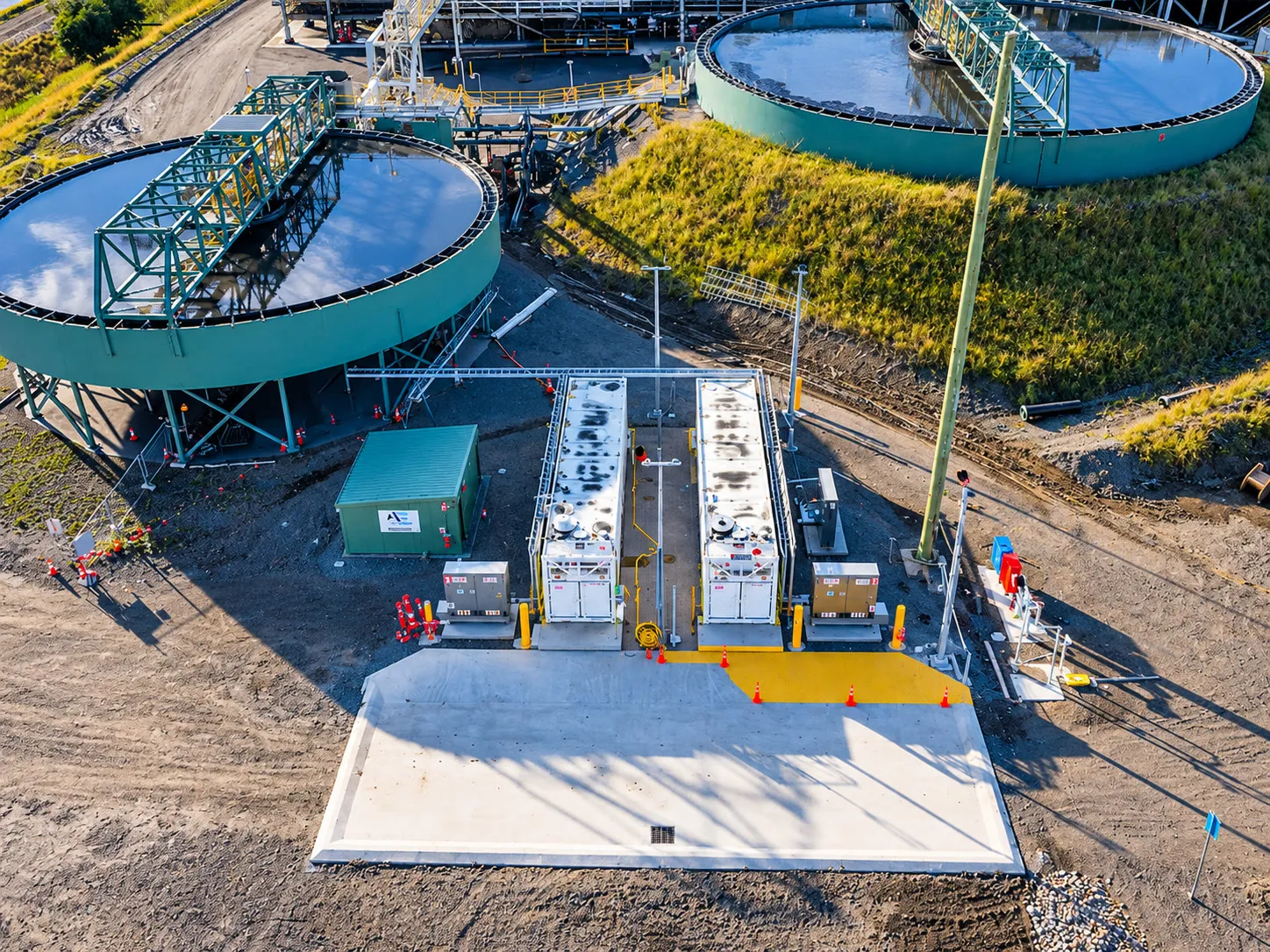 Aerial view of a reagent and flocculant dosing plant beside thickener tanks