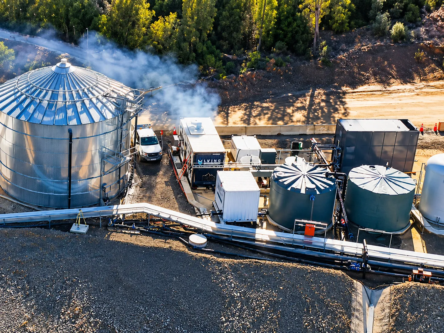 Aerial view of a water treatment plant with a silo, tanks and containerised equipment on a mine site